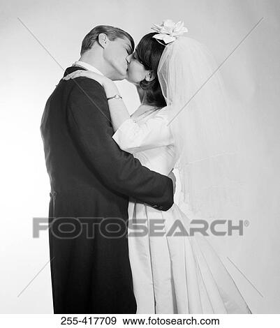 Stock Photo - Newly married couple kissing. Fotosearch
