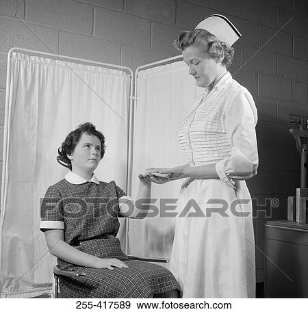 Nurse examining girl in hospital View Large Photo Image Stock Photo - Nurse examining girl in hospital. Fotosearch