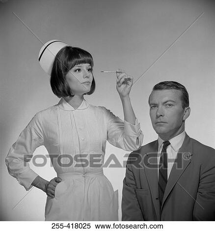 Nurse measuring man's temperature View Large Photo Image Stock Photography - Nurse measuring man's temperature. Fotosearch