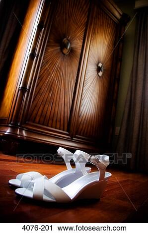 Pair of white female sandals in front of bureau View Large Photo Image Stock Image - Pair of white female sandals in front of bureau. Fotosearch