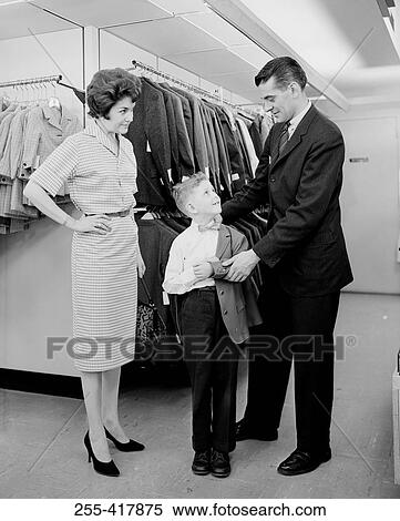 Parents assisting son trying on suit in shop View Large Photo Image Stock Photography - Parents assisting son trying on suit in shop. Fotosearch