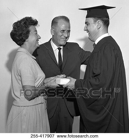 Parents giving gift to son at graduation View Large Photo Image Stock Photo - Parents giving gift to son at graduation. Fotosearch