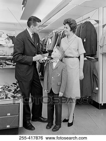 Stock Photograph - Parents with son in clothes shop. Fotosearch