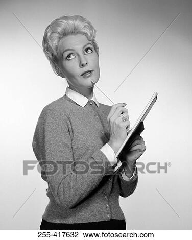 Stock Image - Pensive secretary holding clipboard. Fotosearch