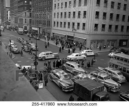 Stock Image - People and cars on streets. Fotosearch