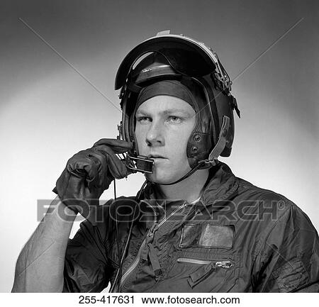 Stock Image - Pilot talking into helmet headset. Fotosearch