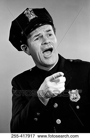 Police officer shouting, while pointing at someone View Large Photo Image Stock Photo - Police officer shouting, while pointing at someone. Fotosearch