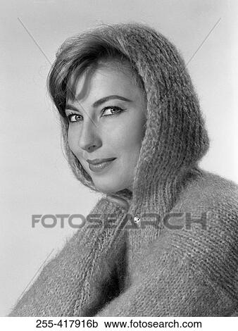 Stock Image - Portrait of beautiful young woman wearing wooly hooded jumper. Fotosearch
