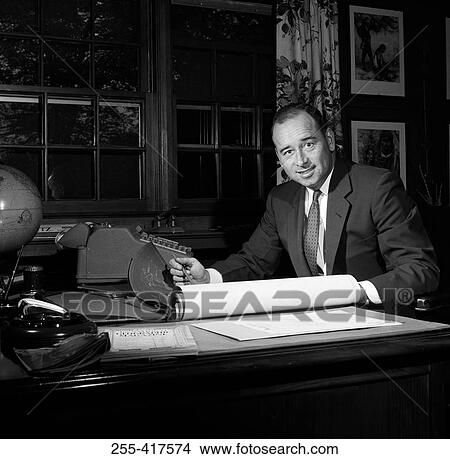 Picture - Portrait of businessman working in office. Fotosearch
