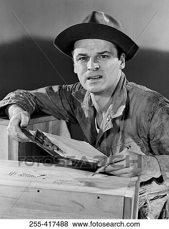 Portrait of carpenter holding clipboard View Large Photo Image Stock Photo - Portrait of carpenter holding clipboard. Fotosearch