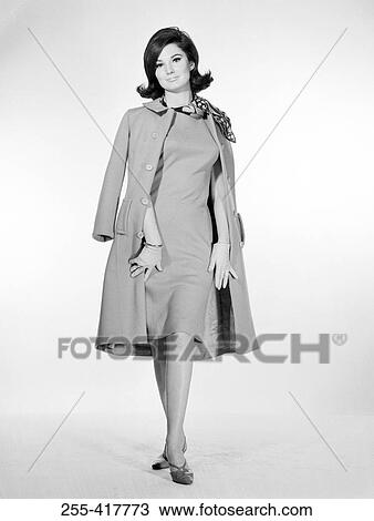 Stock Image - Portrait of elegant young woman looking at camera, studio shot. Fotosearch