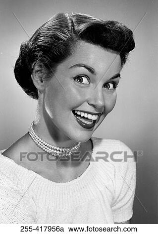 Stock Image - Portrait of excited young woman. Fotosearch
