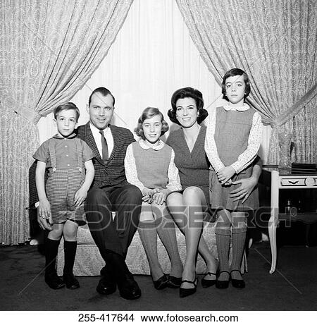Picture - Portrait of family with children in living room. Fotosearch