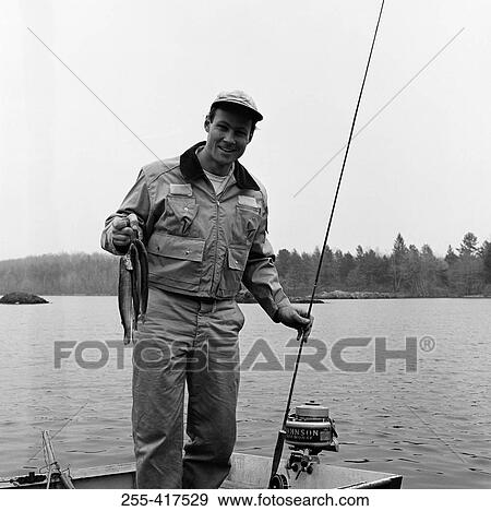 Portrait of man fishing in lake View Large Photo Image Stock Photo - Portrait of man fishing in lake. Fotosearch