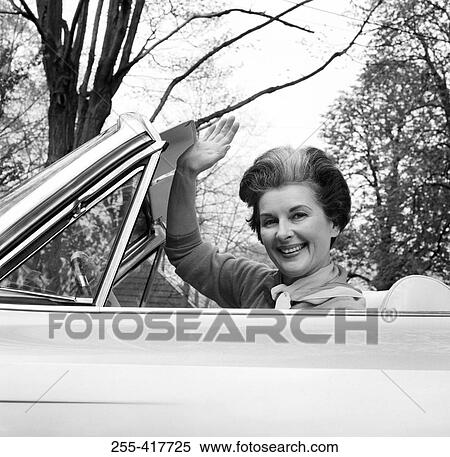 Portrait of mature woman sitting in car, waving View Large Photo Image Stock Photography - Portrait of mature woman sitting in car, waving. Fotosearch