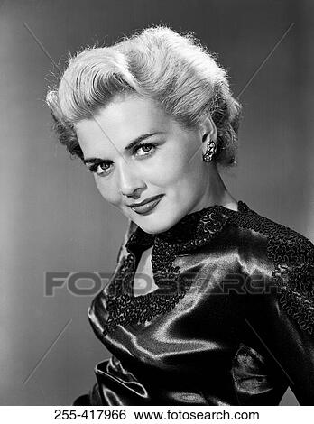 Stock Photograph - Portrait of mid adult woman wearing evening dress. Fotosearch