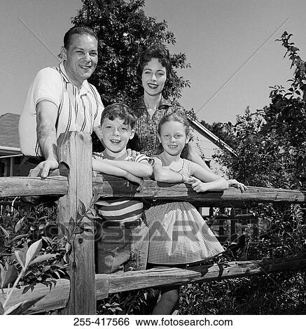 Portrait of parents and kids leaning on farm fence View Large Photo Image Stock Photograph - Portrait of parents and kids leaning on farm fence. Fotosearch