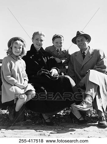 Portrait of parents with kids on bench View Large Photo Image Stock Photo - Portrait of parents with kids on bench. Fotosearch