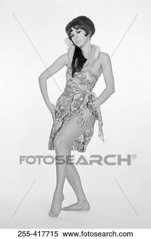 Portrait of pin-up girl pulling up dress View Large Photo Image Stock Photography - Portrait of pin-up girl pulling up dress. Fotosearch