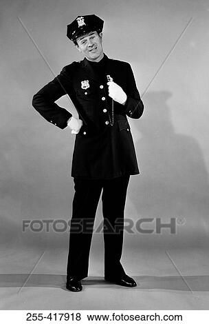 Stock Photo - Portrait of policeman holding whistle. Fotosearch