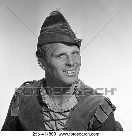 Stock Photo - Portrait of smiling man wearing elf costume, studio shot. Fotosearch