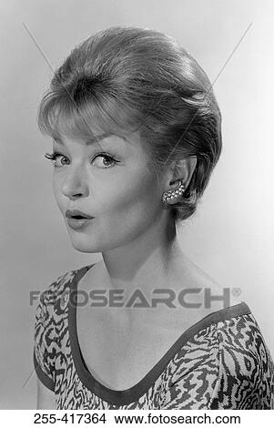Portrait of surprised young woman looking at camera, studio shot View Large Photo Image Picture - Portrait of surprised young woman looking at camera, studio shot. Fotosearch
