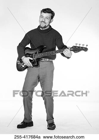 Stock Image - Portrait of young man playing base guitar. Fotosearch