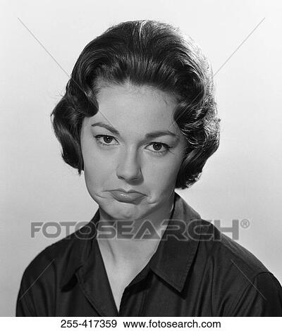 Portrait of young woman making sad face, studio shot View Large Photo Image Stock Photo - Portrait of young woman making sad face, studio shot. Fotosearch