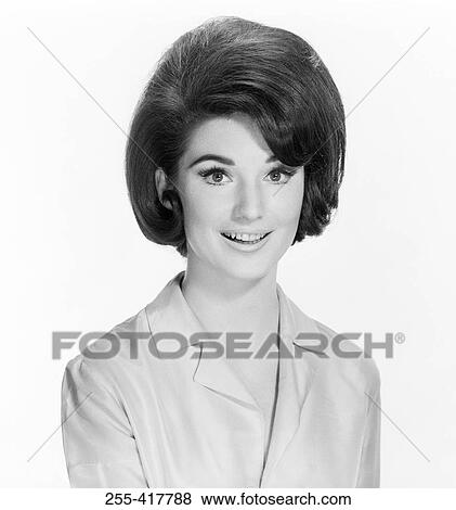 Portrait of young woman smiling, studio shot View Large Photo Image Stock Photo - Portrait of young woman smiling, studio shot. Fotosearch