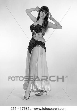 Stock Image - Portrait of young woman wearing belly dance outfit. Fotosearch