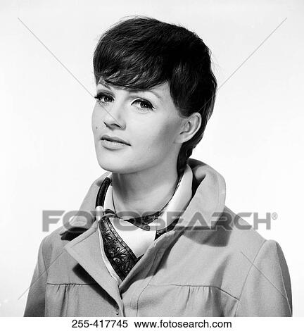 Portrait of young woman wearing overcoat View Large Photo Image Stock Photography - Portrait of young woman wearing overcoat. Fotosearch