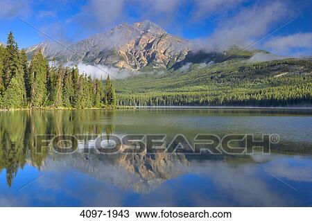 Stock Image - Reflection of a mountain in water, Pyramid Lake, Pyramid Mountain, Jasper National Park, Alberta, Canada. Fotosearch