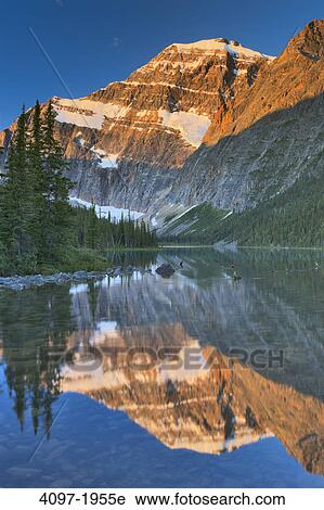 Stock Image - Reflection of a mountain in water, Cavell Lake, Mt Edith Cavell, Jasper National Park, Alberta, Canada. Fotosearch