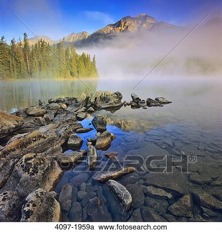 Reflection of a mountain in water, Pyramid Lake, Pyramid Mountain, Jasper National Park, Alberta, Canada View Large Photo Image Stock Image - Reflection of a mountain in water, Pyramid Lake, Pyramid Mountain, Jasper National Park, Alberta, Canada. Fotosearch