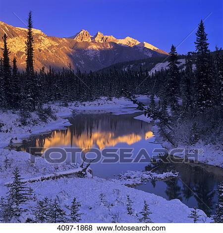 Stock Photo - Reflection of a mountain in water, Jasper National Park, Alberta, Canada. Fotosearch
