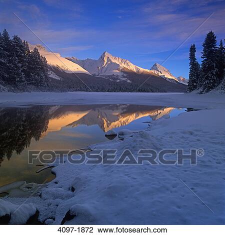 Stock Image - Reflection of mountains in water, Jasper National Park, Alberta, Canada. Fotosearch