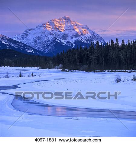 Stock Image - River flowing with a mountain in the background, Athabasca River, Mt Kerkeslin, Jasper National Park, Alberta, Canada. Fotosearch