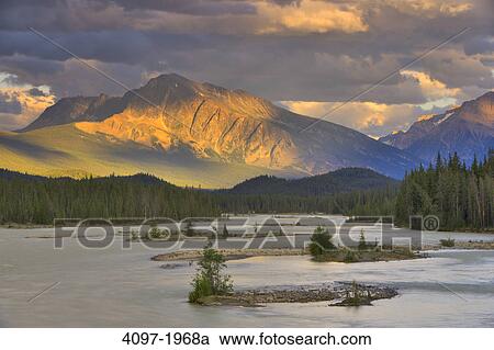 River flowing with a mountain in the background, Athabasca River, Mt Andromeda, Jasper National Park, Alberta, Canada View Large Photo Image Stock Image - River flowing with a mountain in the background, Athabasca River, Mt Andromeda, Jasper National Park, Alberta, Canada. Fotosearch
