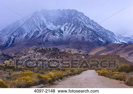 Road passing through a snowcapped mountain range, Buttermilk Road, California, USA View Large Photo Image Stock Photo - Road passing through a snowcapped mountain range, Buttermilk Road, California, USA. Fotosearch