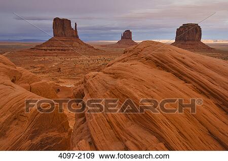 Stock Photo - Rock formations in a desert, Monument Valley, Arizona-Utah, USA. Fotosearch