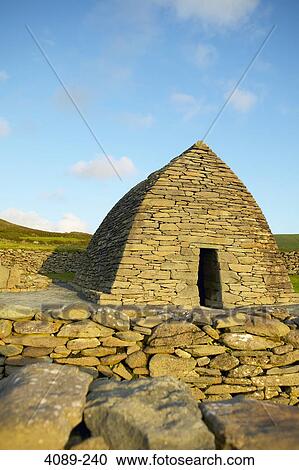 Stock Image - Ruins of a stone church, Gallarus Oratory, Ard na Caithne, Dingle Peninsula, County Kerry, Republic of Ireland. Fotosearch