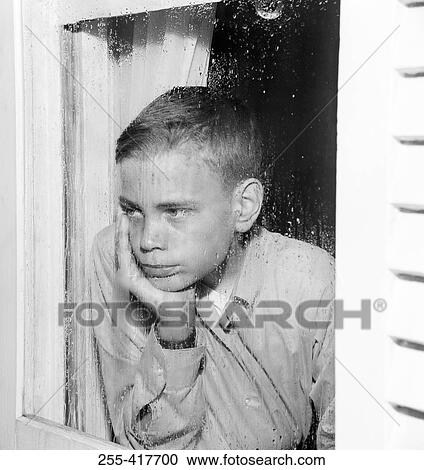 Sad boy looking through window View Large Photo Image Stock Image - Sad boy looking through window. Fotosearch