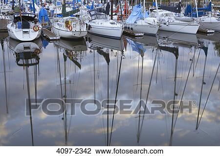 Stock Image - Sailboats in a stream, False Creek, Vancouver, British Columbia, Canada. Fotosearch