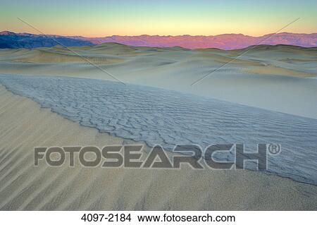 Sand dunes in a desert with a mountain range in the background, Mesquite Flat Sand Dunes, Panamint Range, Death Valley National Park, California, USA View Large Photo Image Picture - Sand dunes in a desert with a mountain range in the background, Mesquite Flat Sand Dunes, Panamint Range, Death Valley National Park, California, USA. Fotosearch