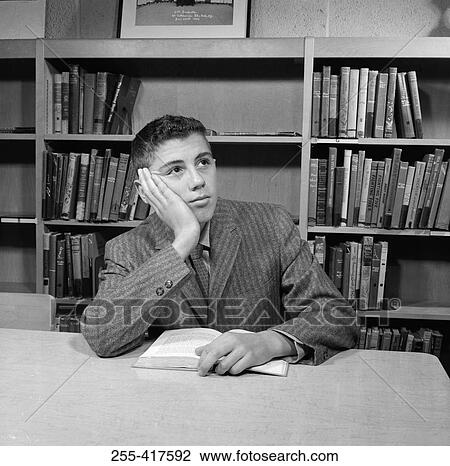 School boy reading in library View Large Photo Image Stock Image - School boy reading in library. Fotosearch