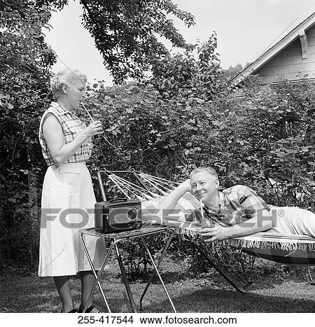 Picture - Senior couple relaxing in backyard. Fotosearch