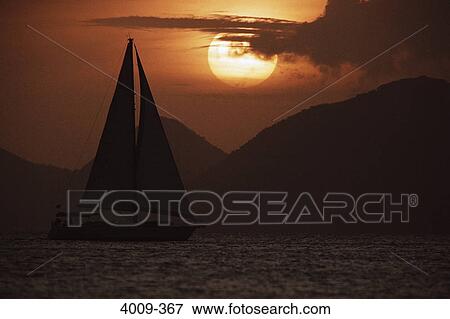 Silhouette of a sailboat in the ocean, British Virgin Islands View Large Photo Image Stock Photo - Silhouette of a sailboat in the ocean, British Virgin Islands. Fotosearch
