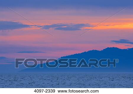 Stock Photo - Silhouette of an island at dusk, English Bay, Vancouver, British Columbia, Canada. Fotosearch