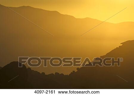 Stock Image - Silhouette of mountains at sunrise, Alabama Hills, Californian Sierra Nevada, California, USA. Fotosearch