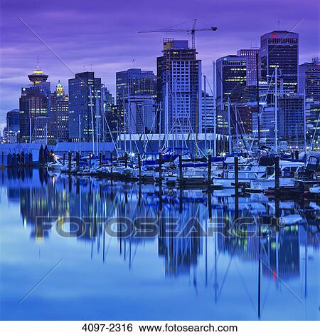 Skyscrapers in a city lit up at dusk, Coal Harbor, Vancouver, British Columbia, Canada View Large Photo Image Stock Photograph - Skyscrapers in a city lit up at dusk, Coal Harbor, Vancouver, British Columbia, Canada. Fotosearch